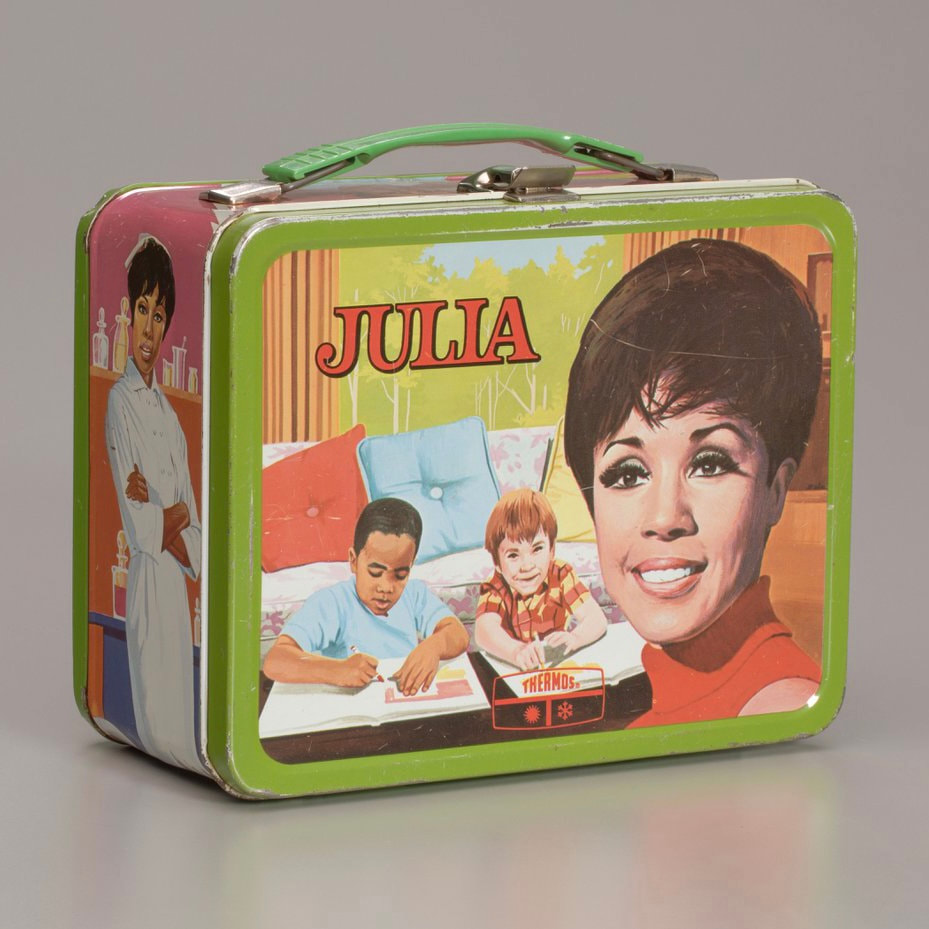 a photo of the front of a vintage Julia themed lunch box.